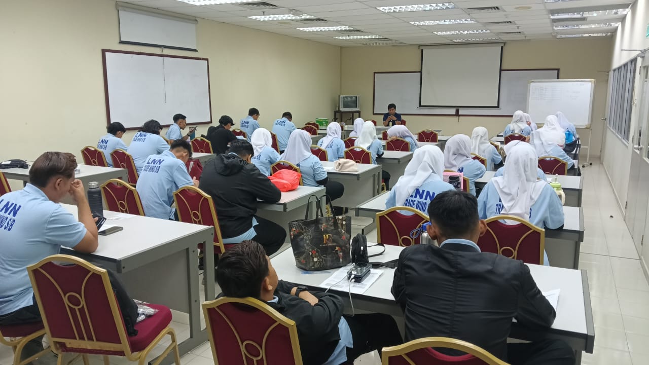 A workforce briefing with participants wearing light blue LNN uniforms